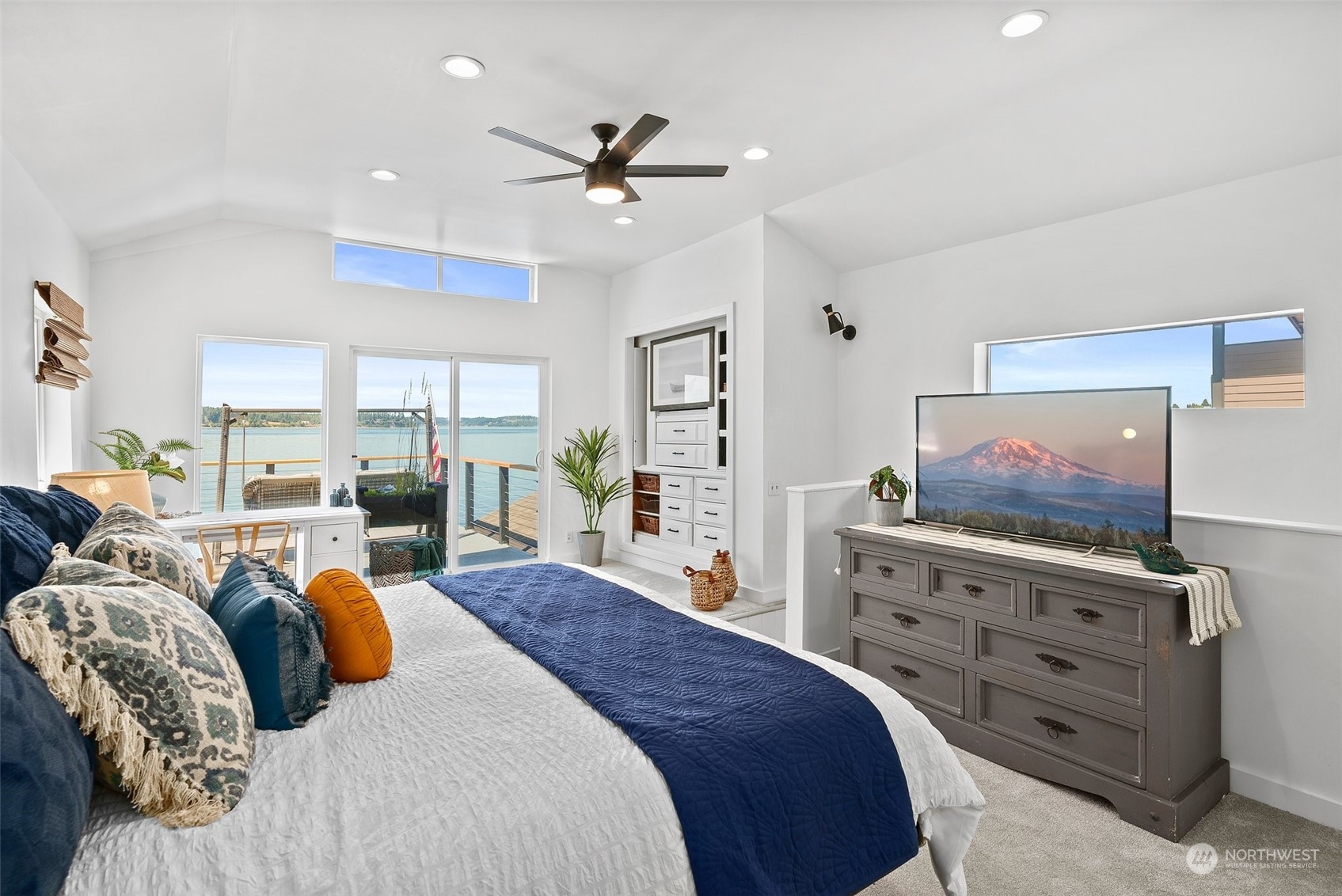 4234 Sunset Beach Road University Place, WA 98466 - Photo 25 of 40 a bedroom with a bed and glass wall
