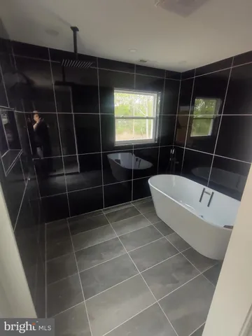 a bathroom with a bathtub and shower