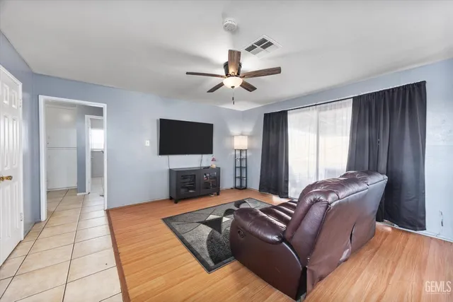 a bedroom with furniture and a flat screen tv