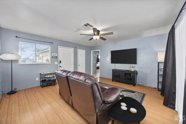 a living room with furniture and a wooden floor