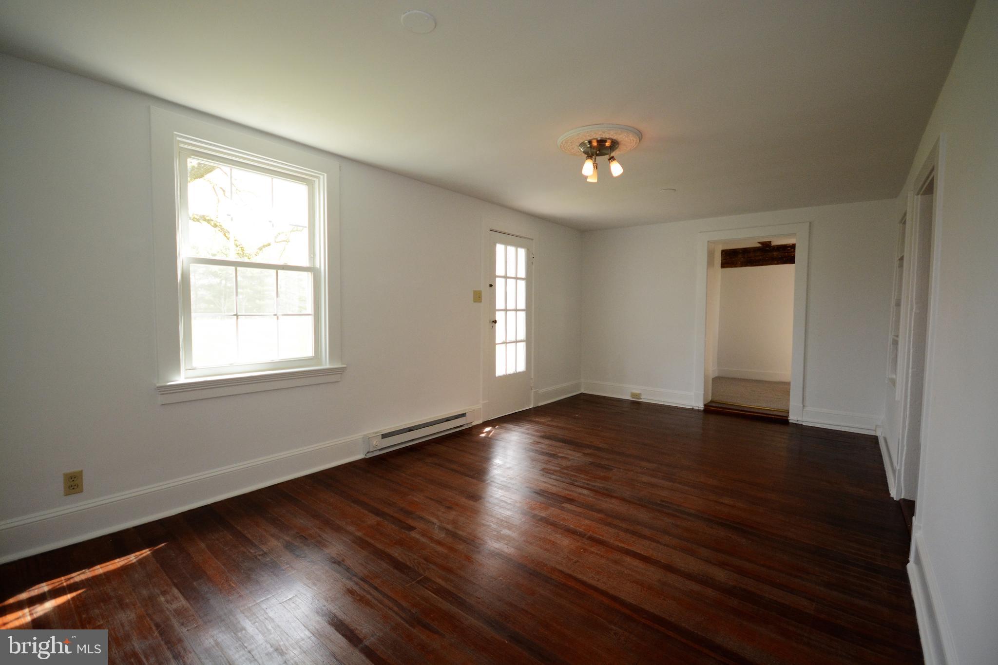 12108 Auburn Road Thurmont, MD 21788 - Photo 12 of 33 a view of an empty room with wooden floor and a window