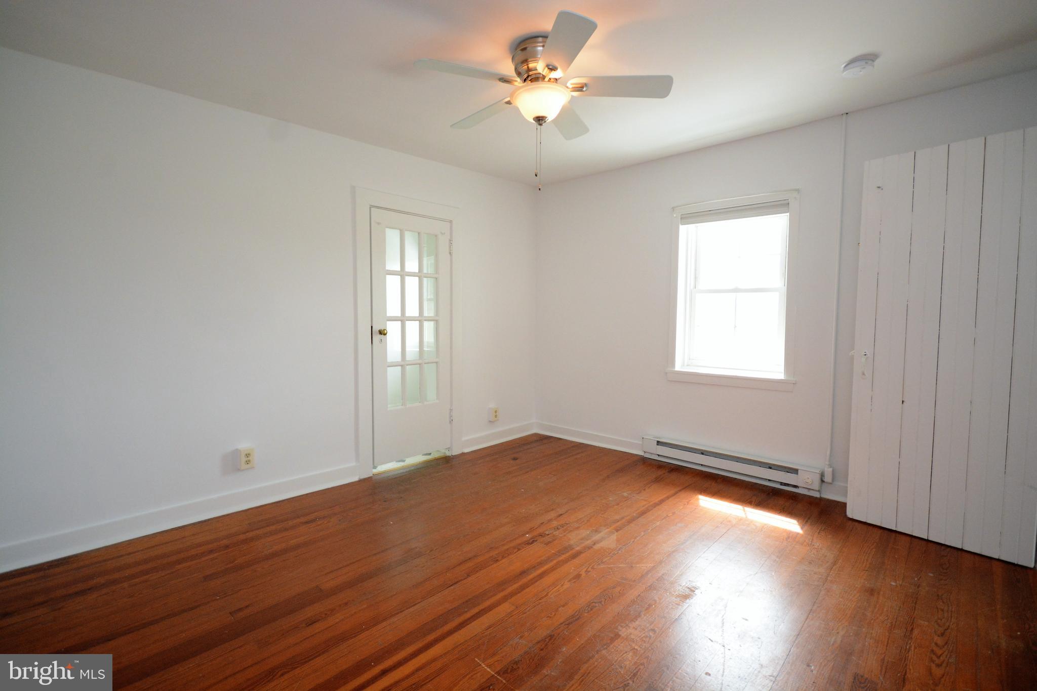 12108 Auburn Road Thurmont, MD 21788 - Photo 13 of 33 an empty room with wooden floor and windows