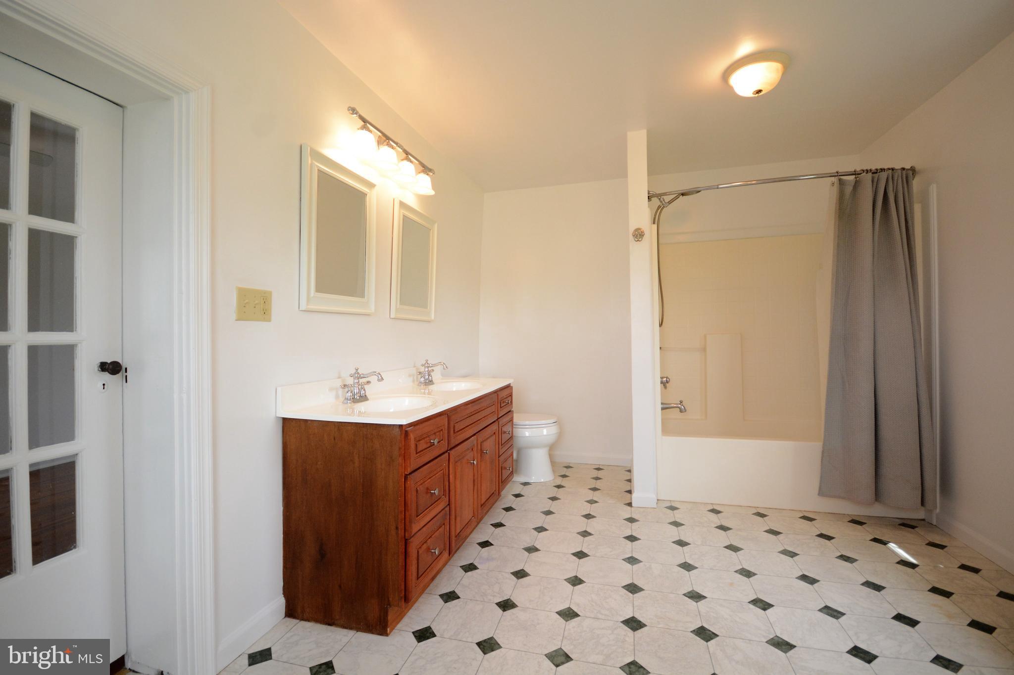 12108 Auburn Road Thurmont, MD 21788 - Photo 15 of 33 a bathroom with a sink a mirror and a bathtub