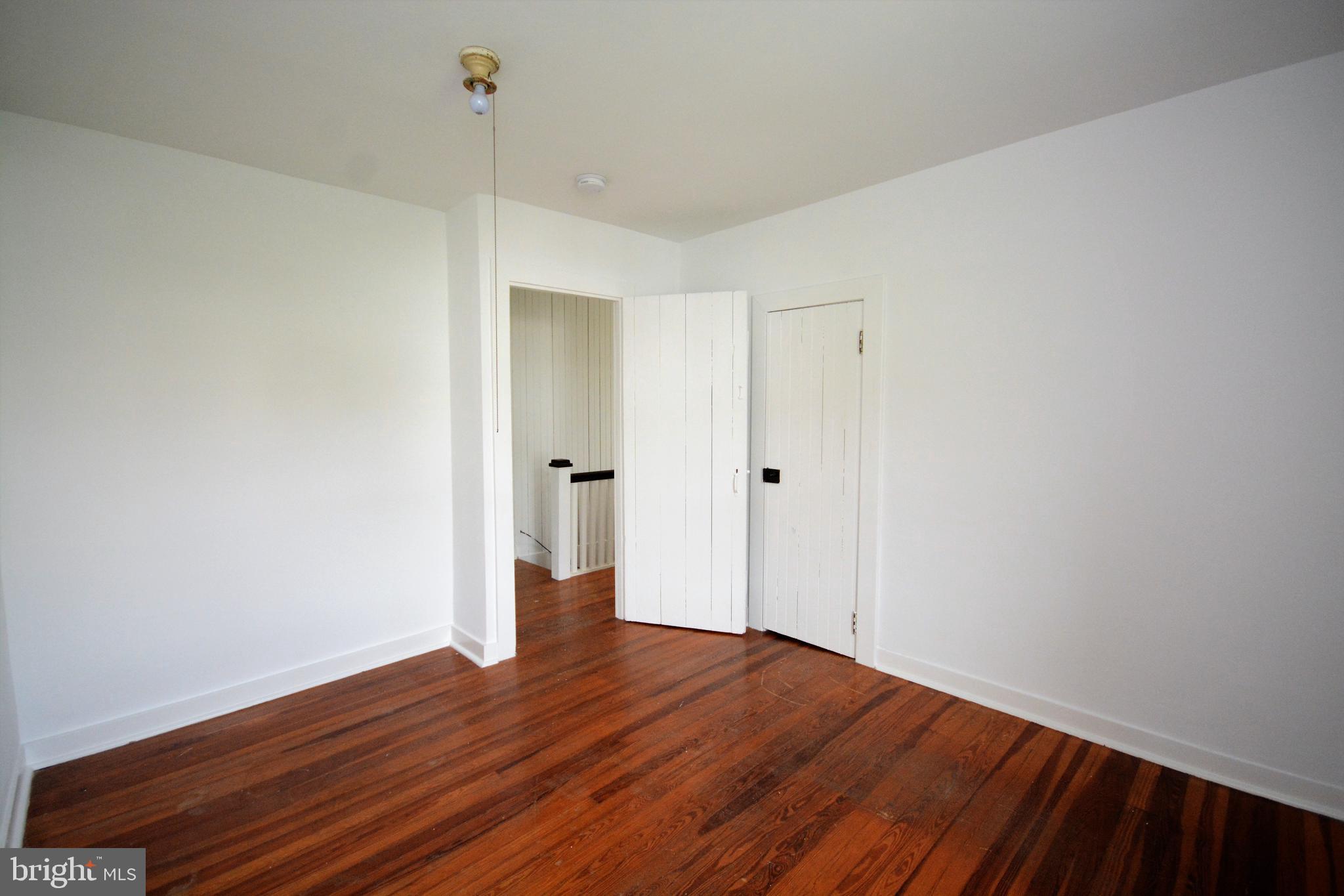 12108 Auburn Road Thurmont, MD 21788 - Photo 20 of 33 a view of an empty room with wooden floor and a ceiling fan