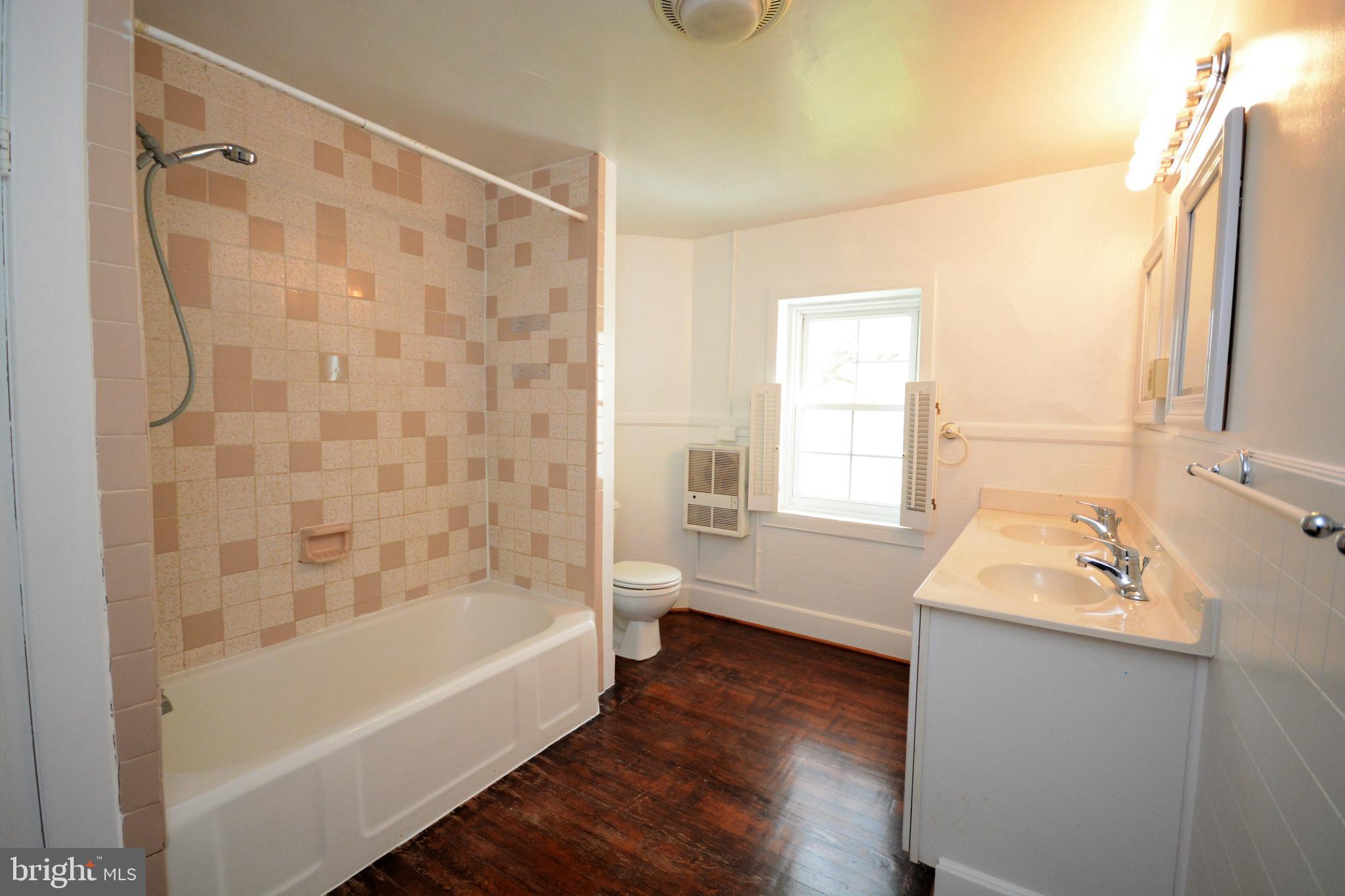 12108 Auburn Road Thurmont, MD 21788 - Photo 22 of 33 a bathroom with a tub a sink and a window
