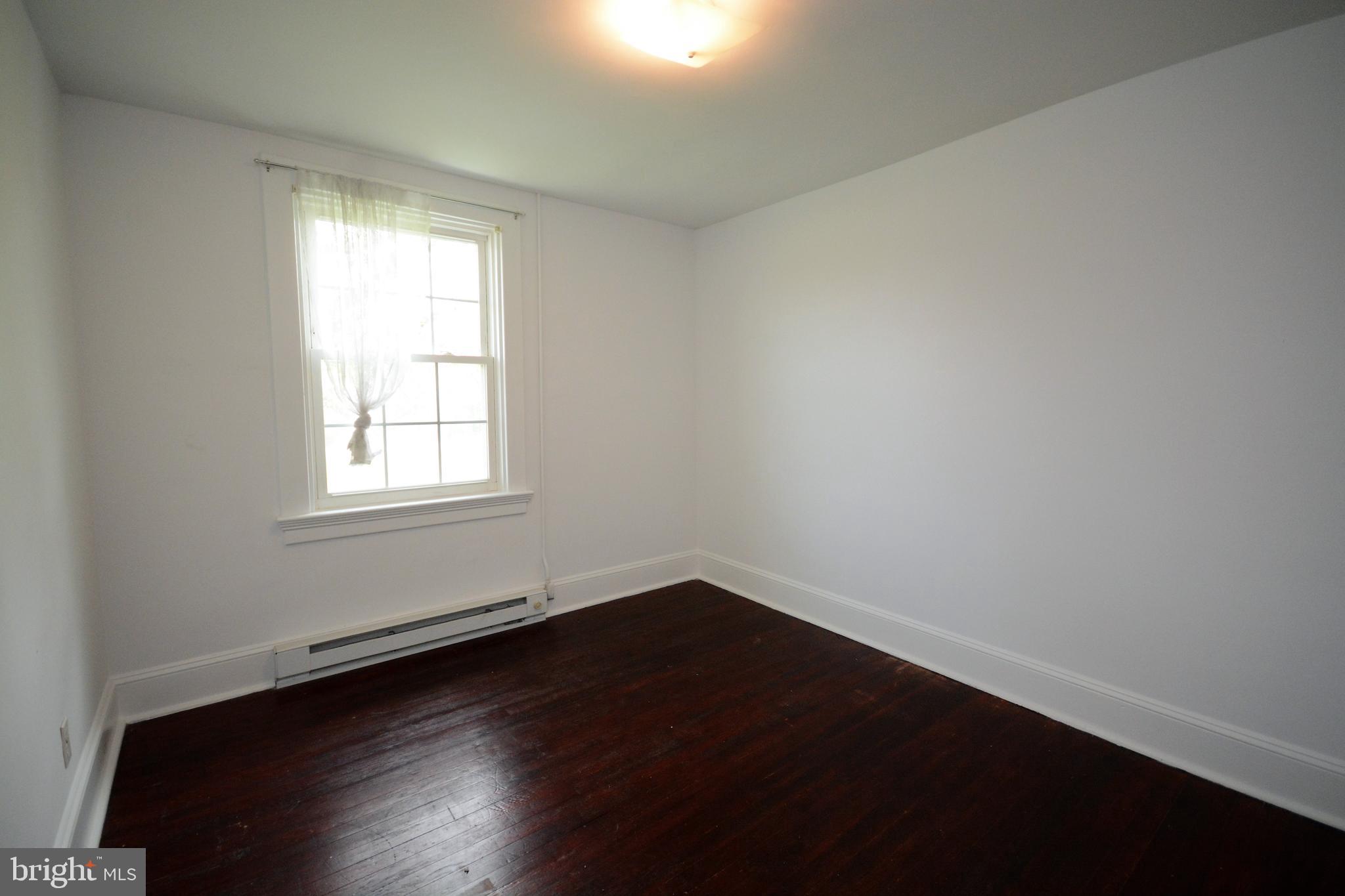 12108 Auburn Road Thurmont, MD 21788 - Photo 24 of 33 an empty room with wooden floor and windows