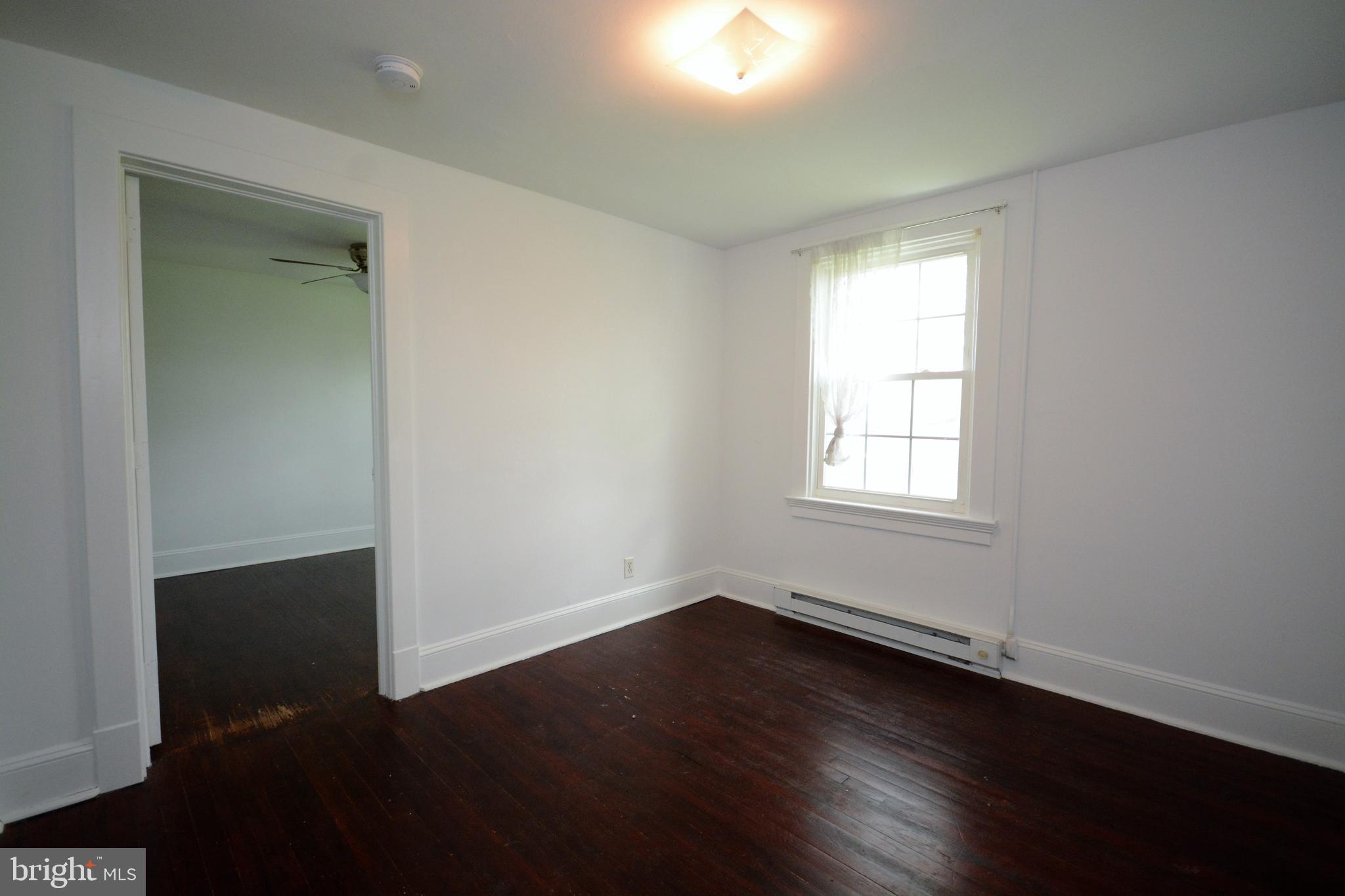 12108 Auburn Road Thurmont, MD 21788 - Photo 25 of 33 an empty room with wooden floor and windows
