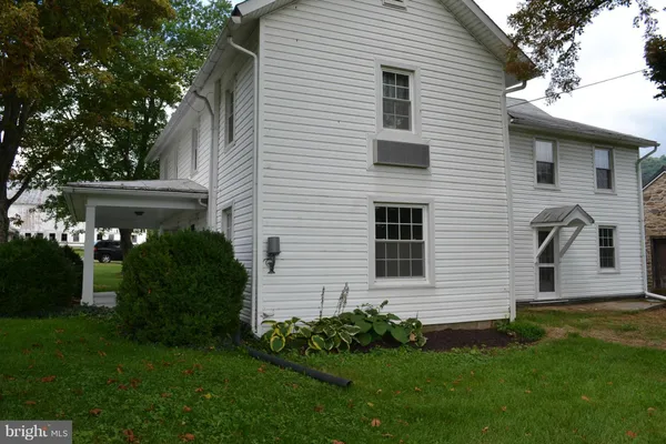 a view of a house with a yard and a garden