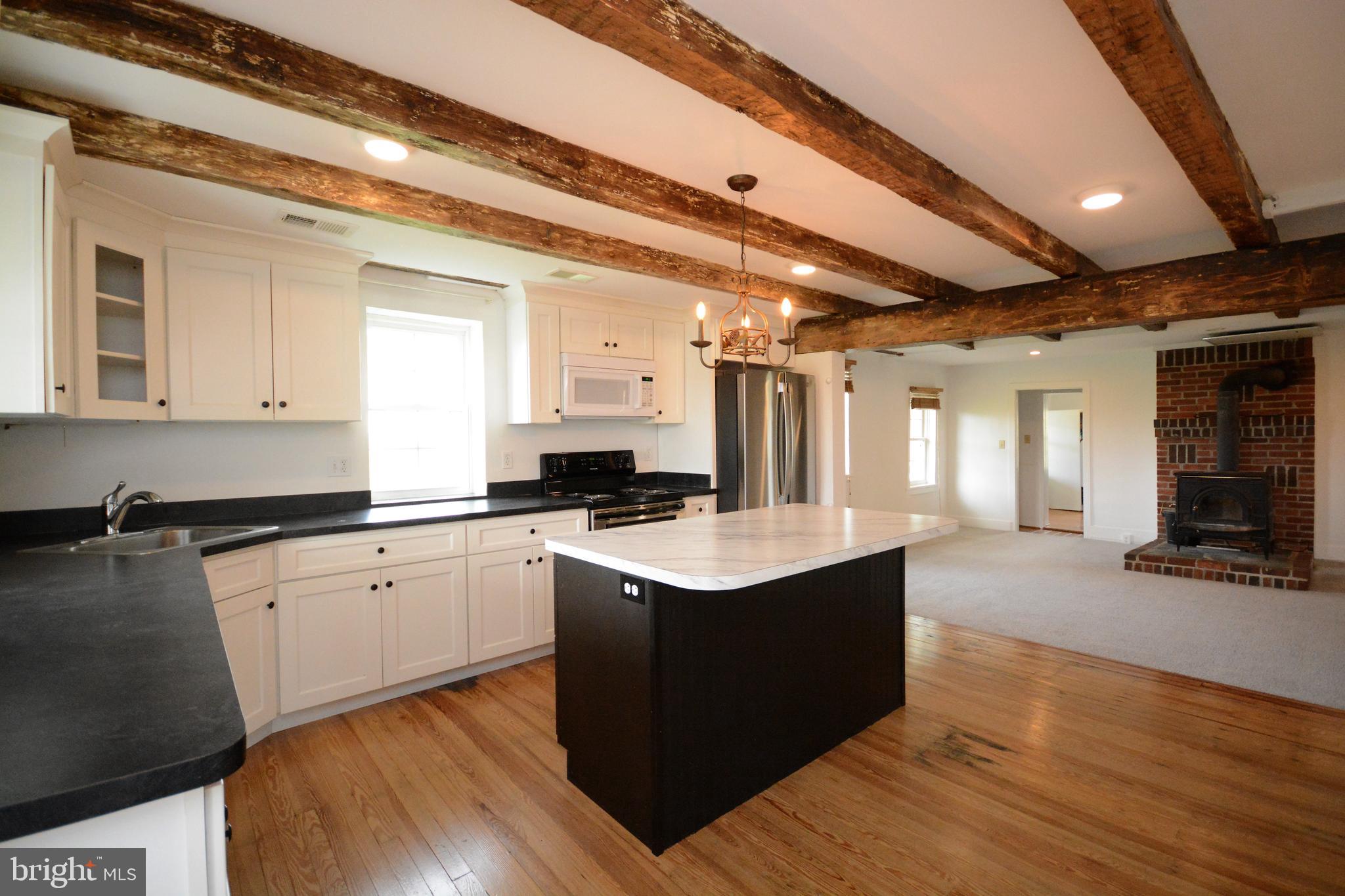 12108 Auburn Road Thurmont, MD 21788 - Photo 4 of 33 a kitchen with sink cabinets and wooden floor