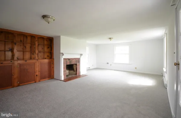 a view of empty room with a fireplace