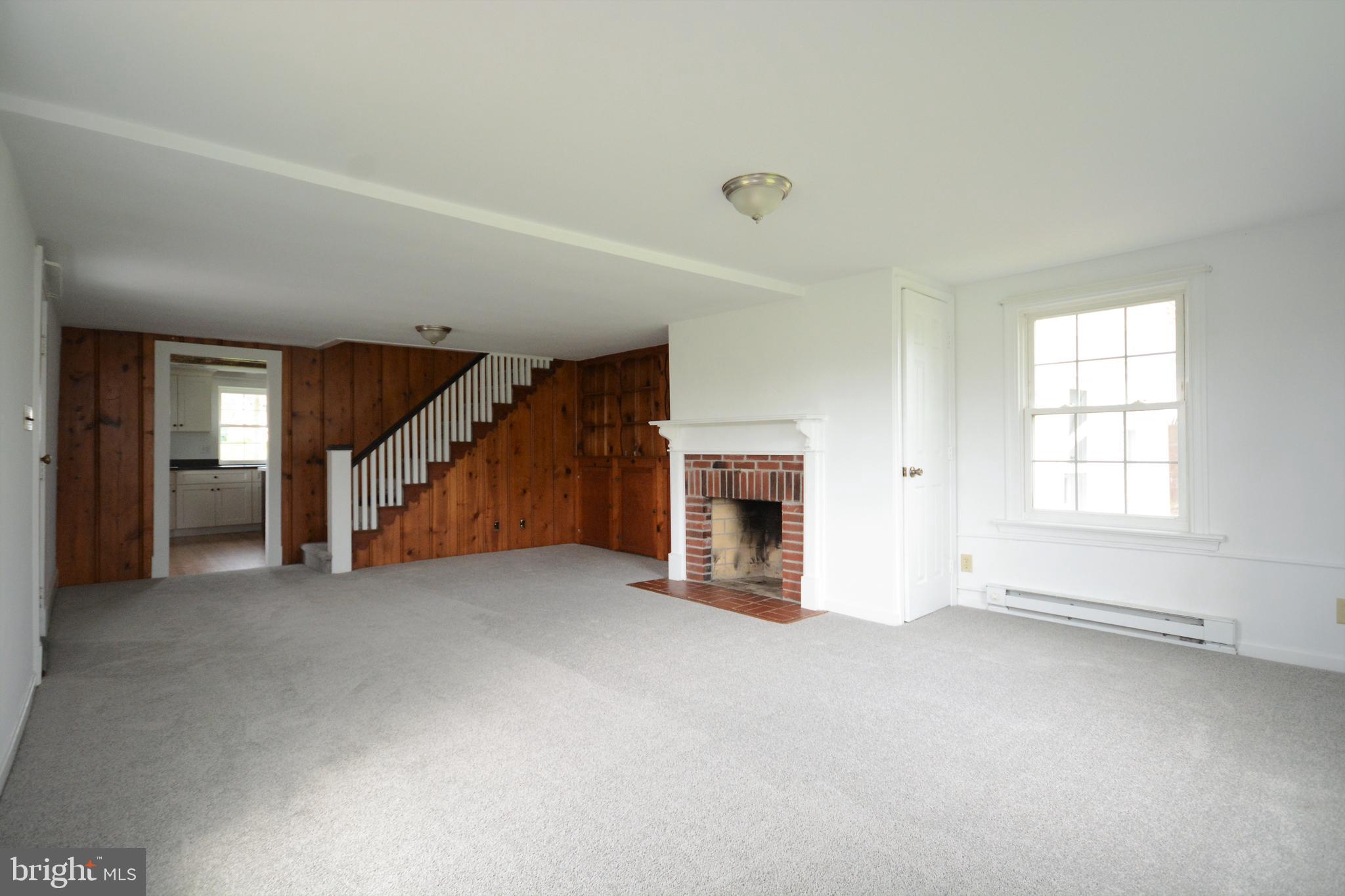 12108 Auburn Road Thurmont, MD 21788 - Photo 10 of 33 an empty room with fireplace and windows