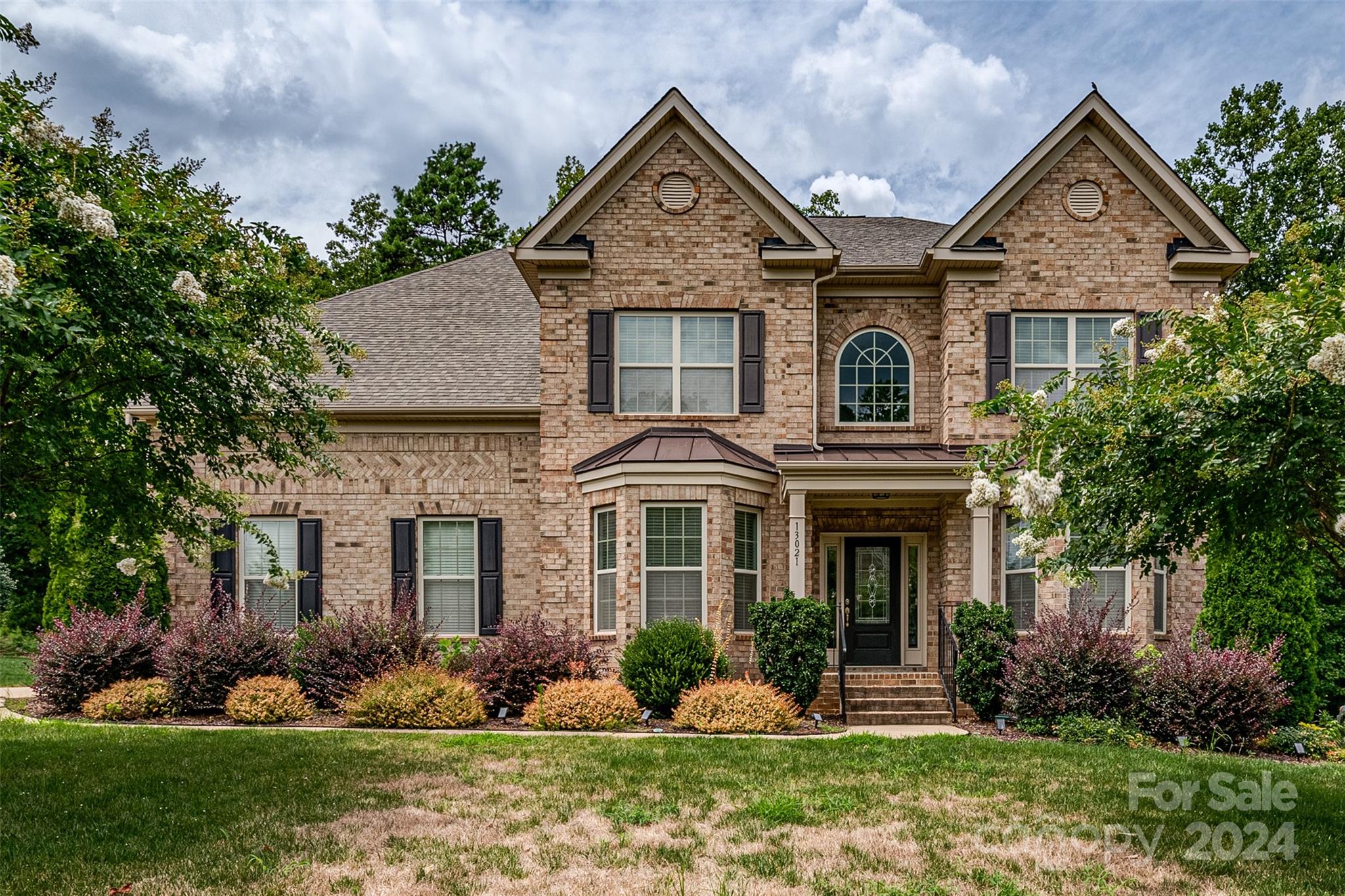 front view of a house with a yard