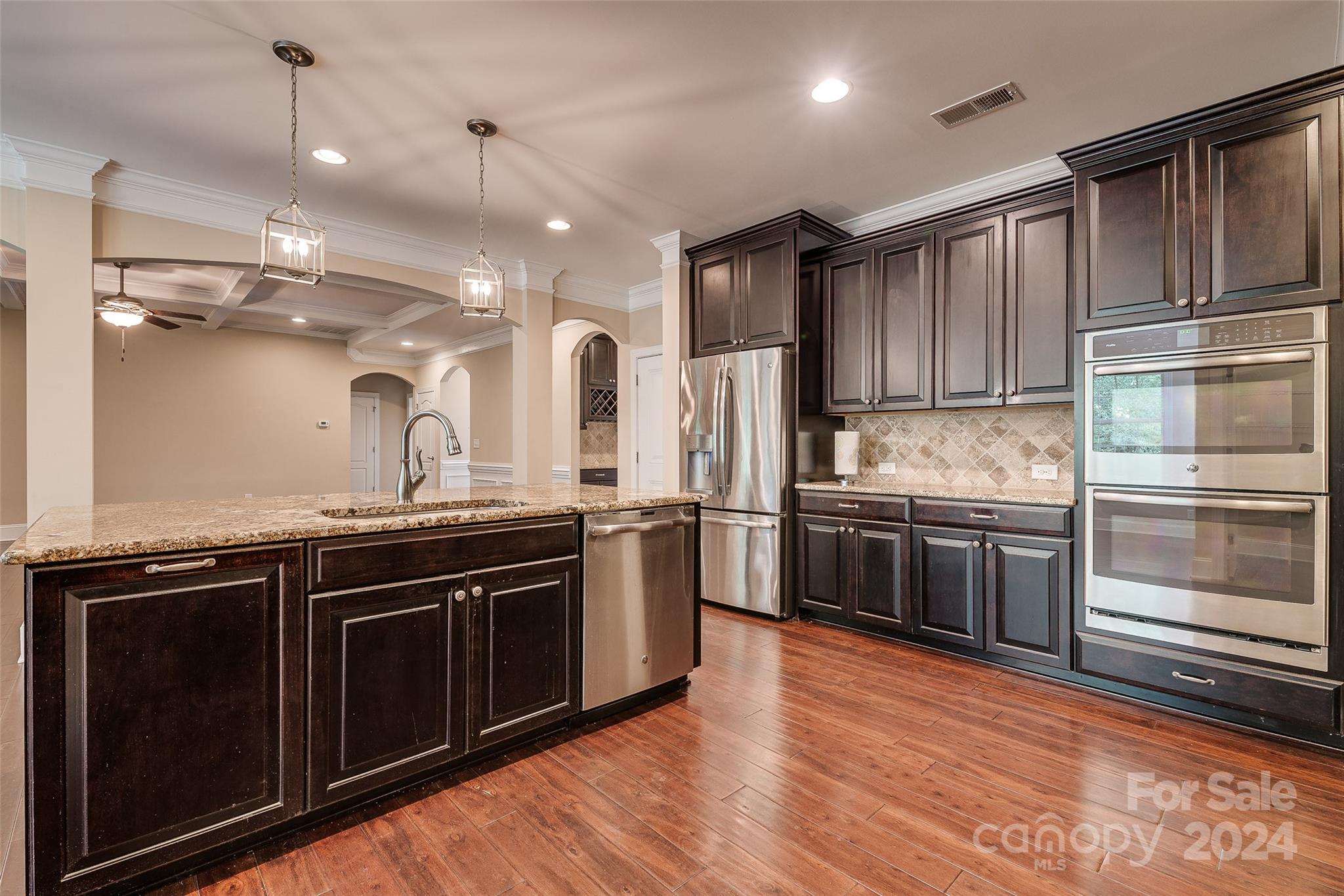 13021 Pumpkin Way Drive Mint Hill, NC 28227 - Photo 13 of 41 a kitchen with stainless steel appliances and wooden cabinets