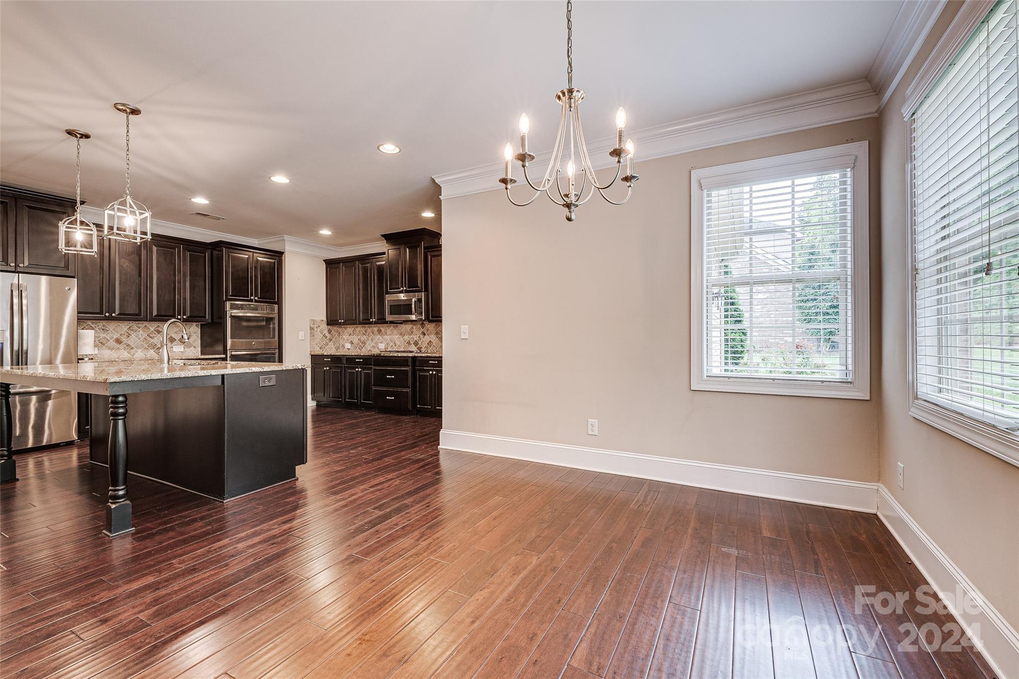 13021 Pumpkin Way Drive Mint Hill, NC 28227 - Photo 14 of 41 a view of a kitchen with granite countertop stainless steel appliances refrigerator wooden floor and a large window