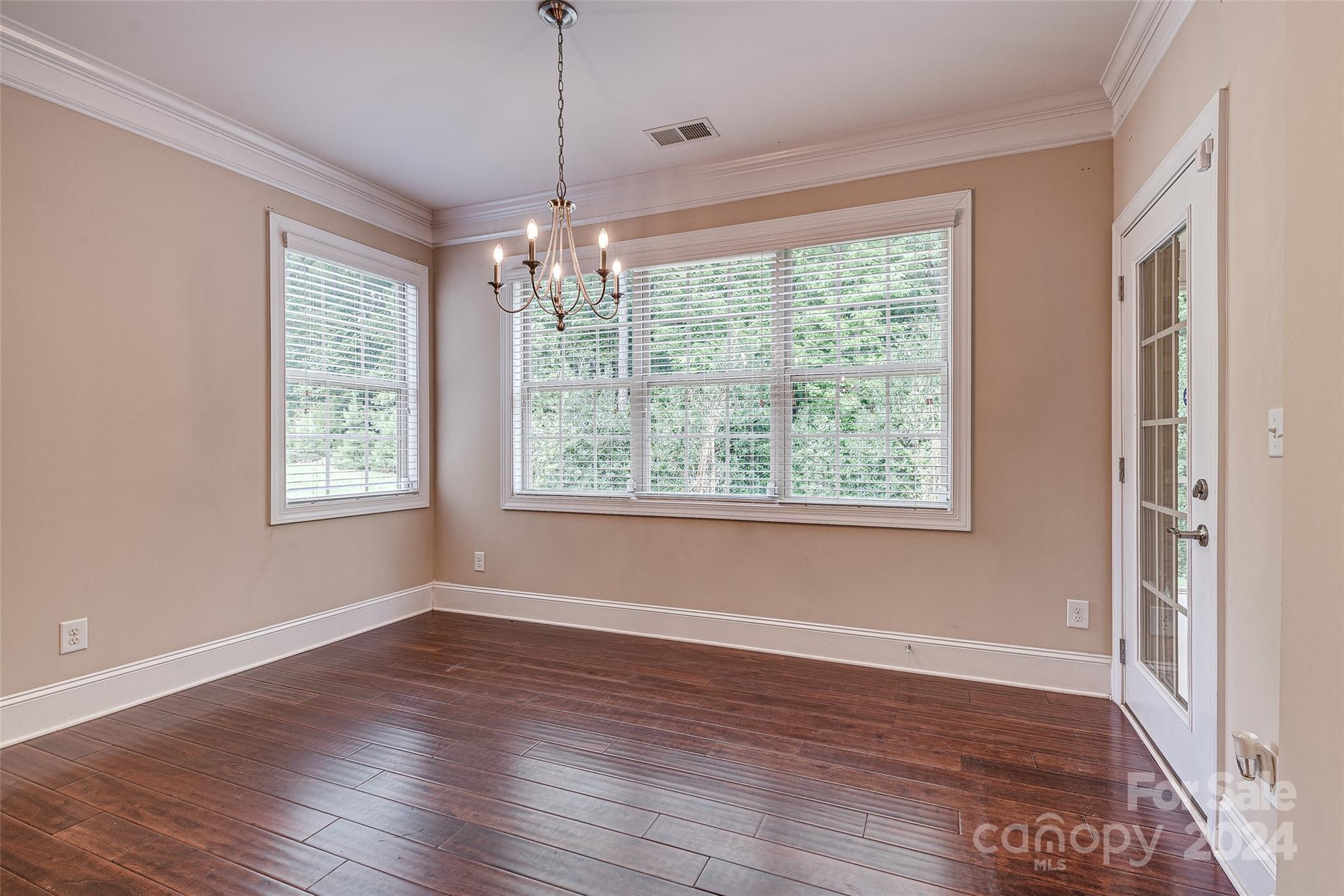 13021 Pumpkin Way Drive Mint Hill, NC 28227 - Photo 15 of 41 a view of an empty room with wooden floor and a window