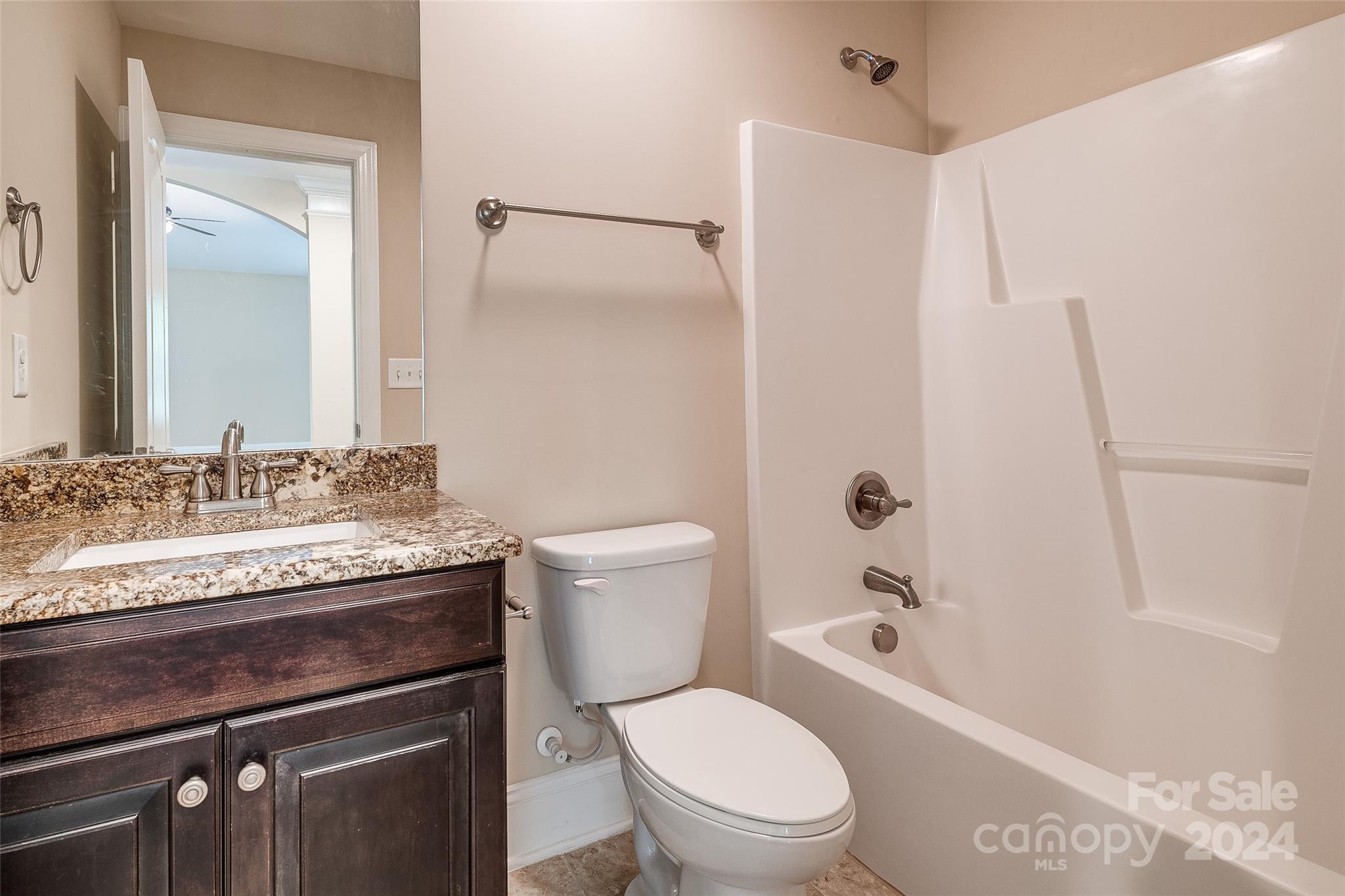 13021 Pumpkin Way Drive Mint Hill, NC 28227 - Photo 23 of 41 a bathroom with a granite countertop sink a toilet and shower
