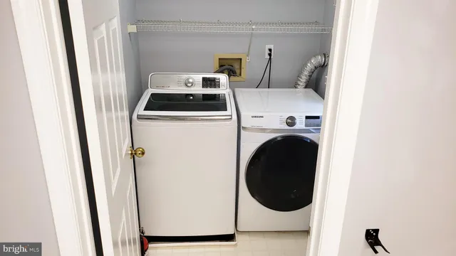 a wooden deck with a tree and swing