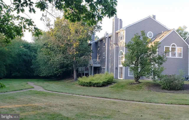 a view of a wooden deck with a backyard