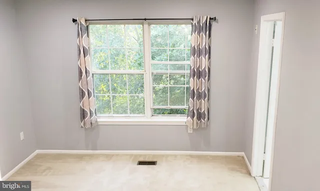 a view of an empty room with windows