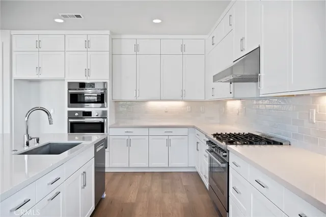 a view of a kitchen with a microwave and a stove