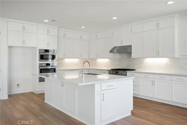 an empty room with wooden floor and a floor to ceiling window