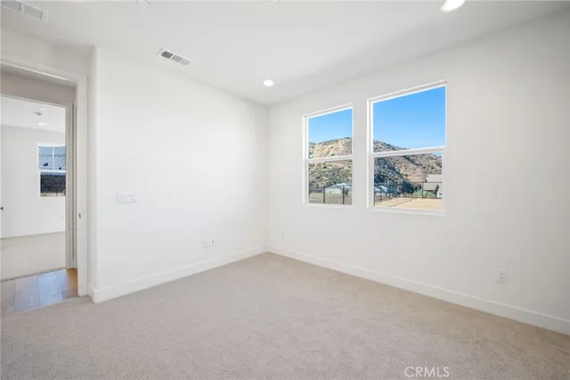 a view of staircase with white walls and a window