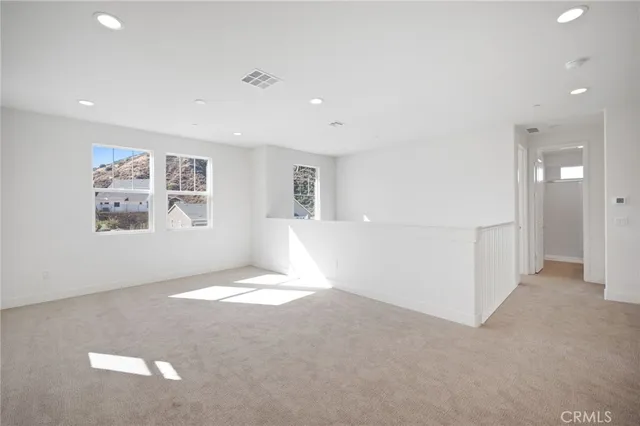 a view of a house with a big yard and large trees