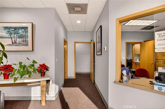 a view of a hallway and a livingroom with furniture