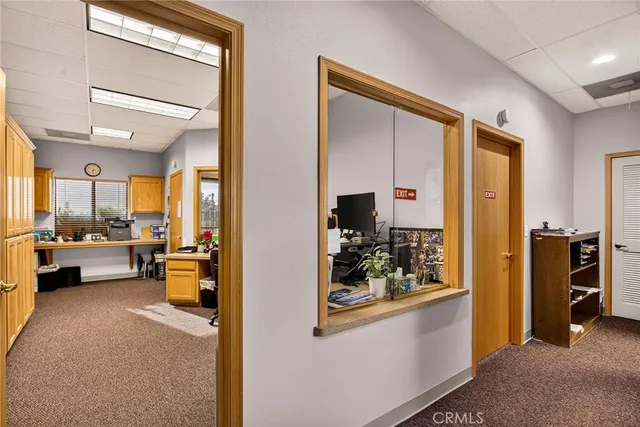a view of living room kitchen and stainless steel appliances wooden floor