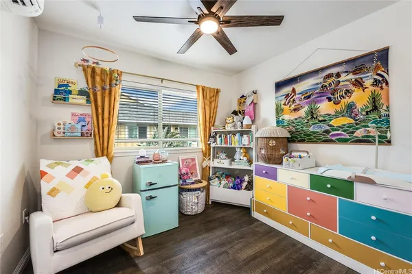 a bedroom with furniture and a flat screen tv