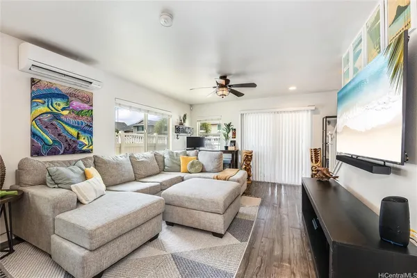 a living room with fireplace furniture and a flat screen tv