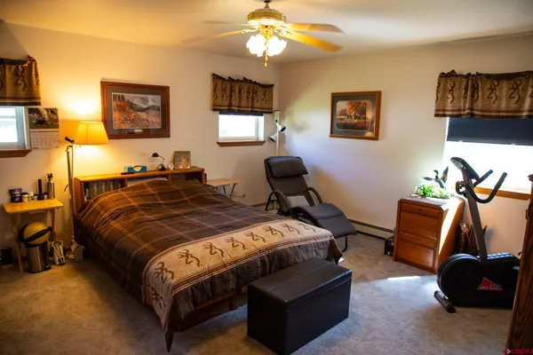 a bathroom with a granite countertop toilet sink and mirror