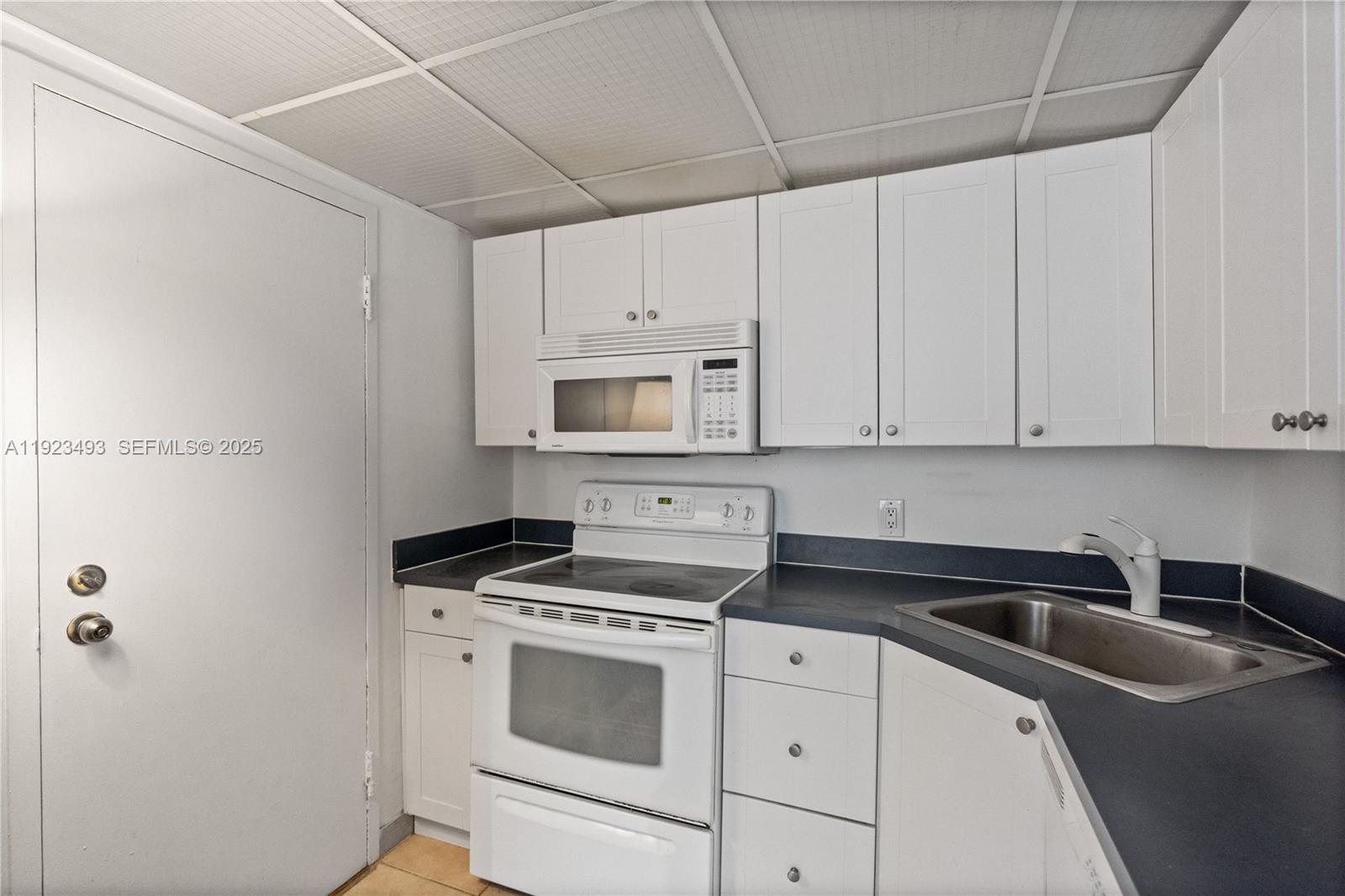 800 West Avenue, Unit 722 Miami Beach, FL 33139 - Photo 13 of 33 a kitchen with cabinets appliances a sink and a counter top