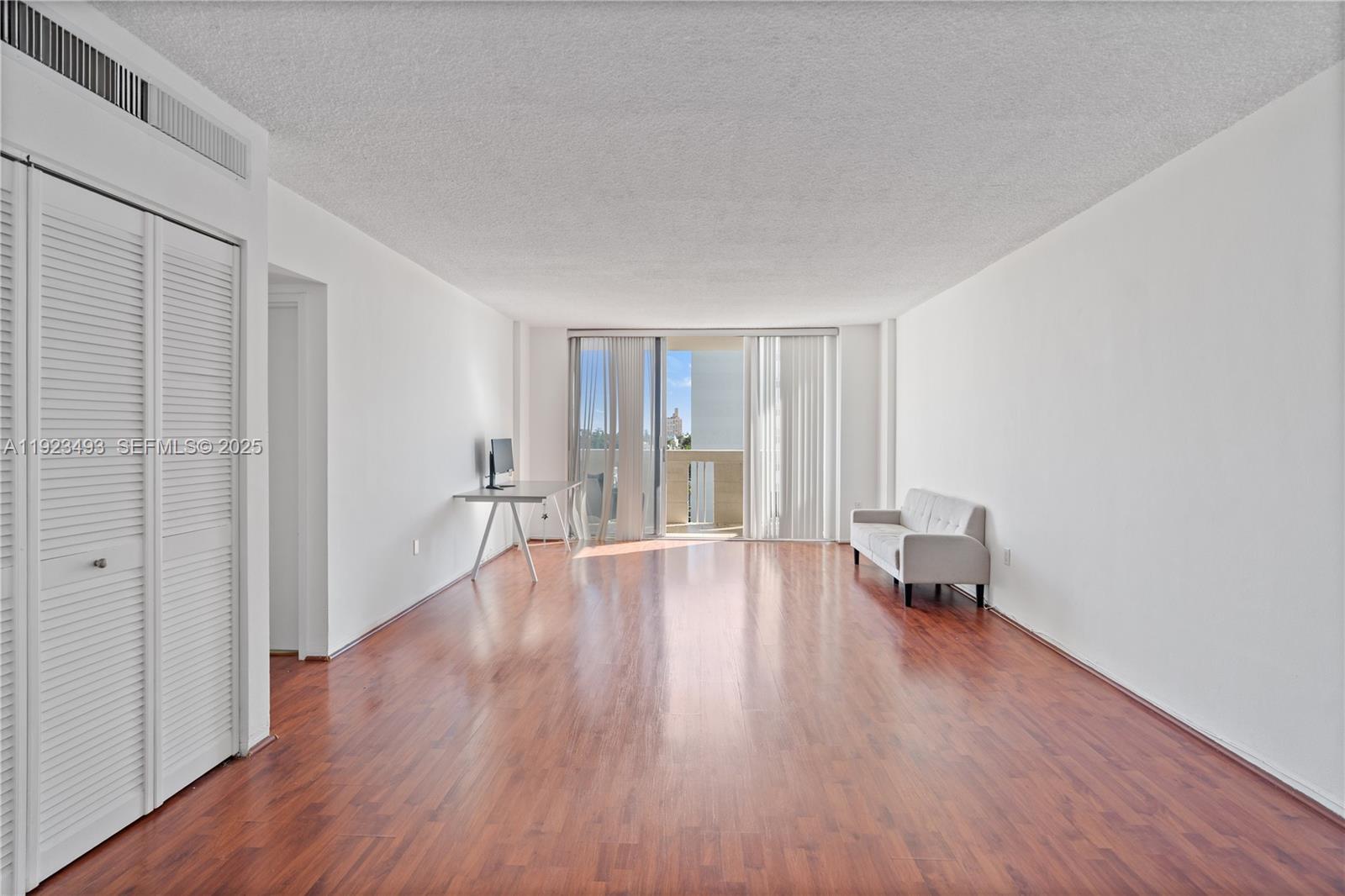 800 West Avenue, Unit 722 Miami Beach, FL 33139 - Photo 3 of 33 a view of empty room with wooden floor and fan
