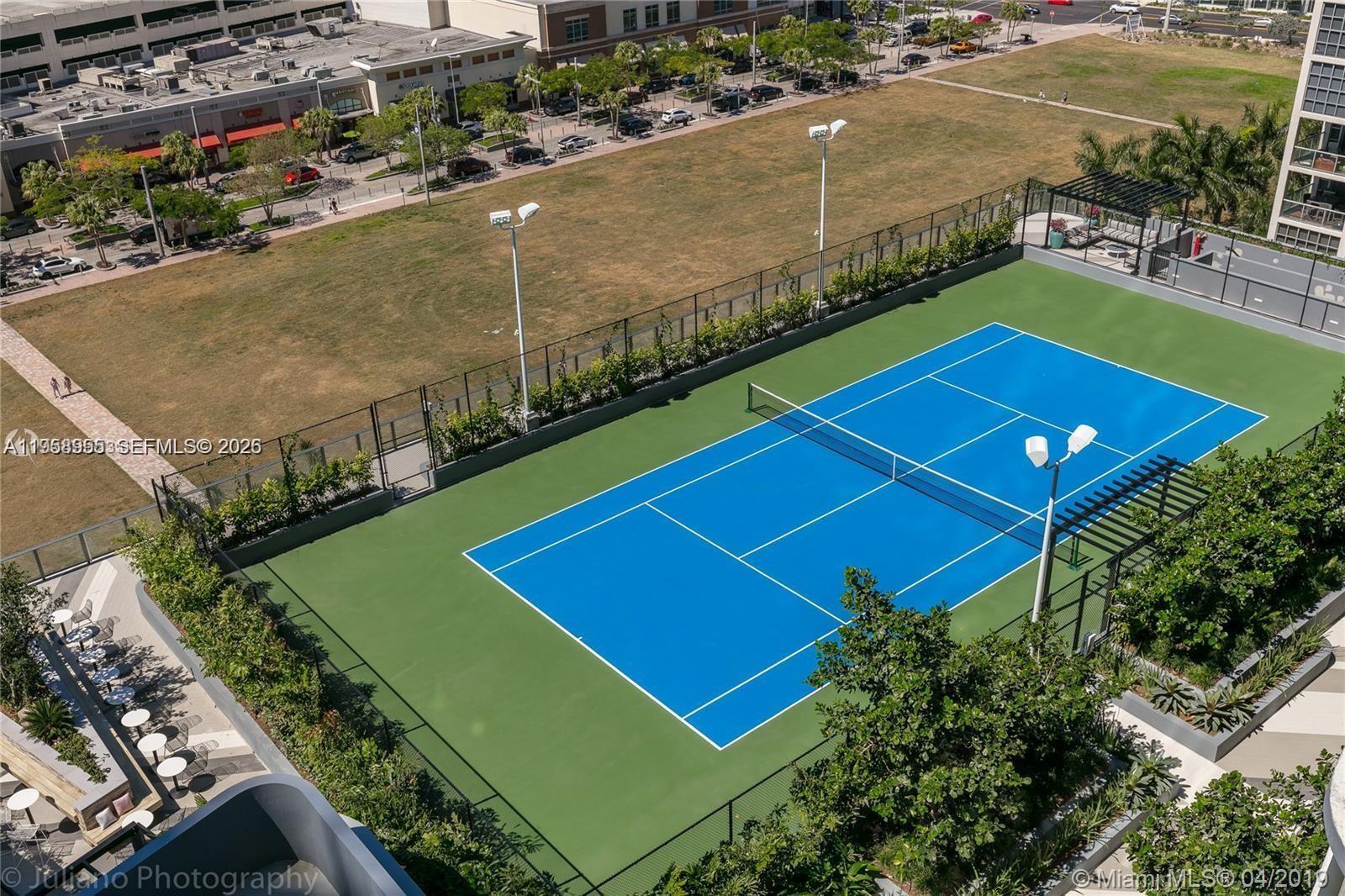 121 Northeast 34th Street, Unit 2816 Miami, FL 33137 - Photo 3 of 28 an aerial view of a tennis ground and a cars park side of the road