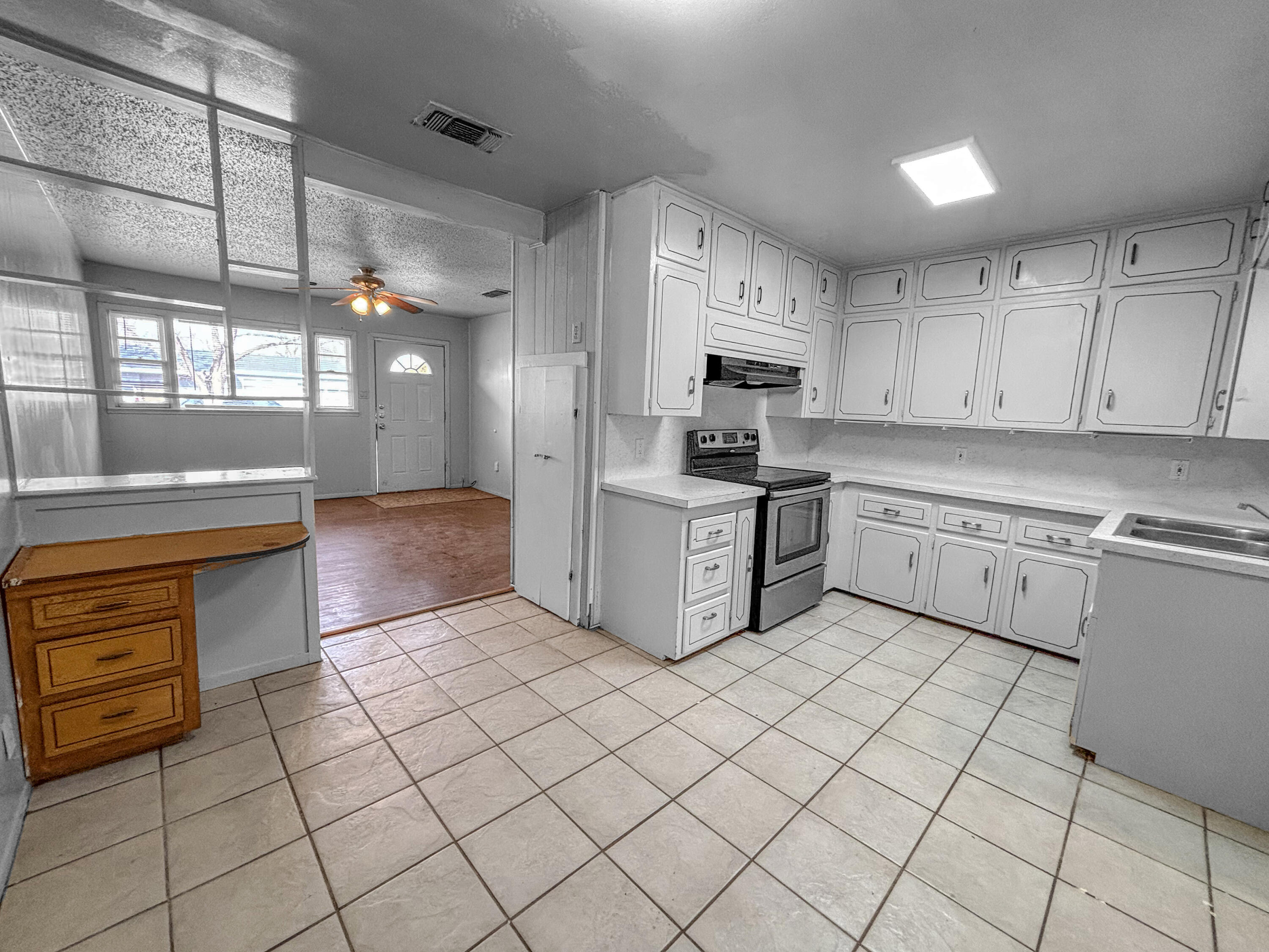 4411 45th Street Lubbock, TX 79414 - Photo 14 of 44 a kitchen with stainless steel appliances granite countertop a sink and cabinets