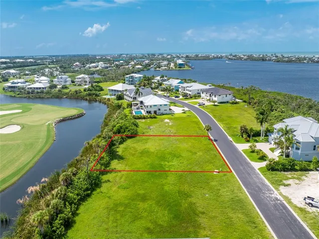 an aerial view of a house with a garden and lake view