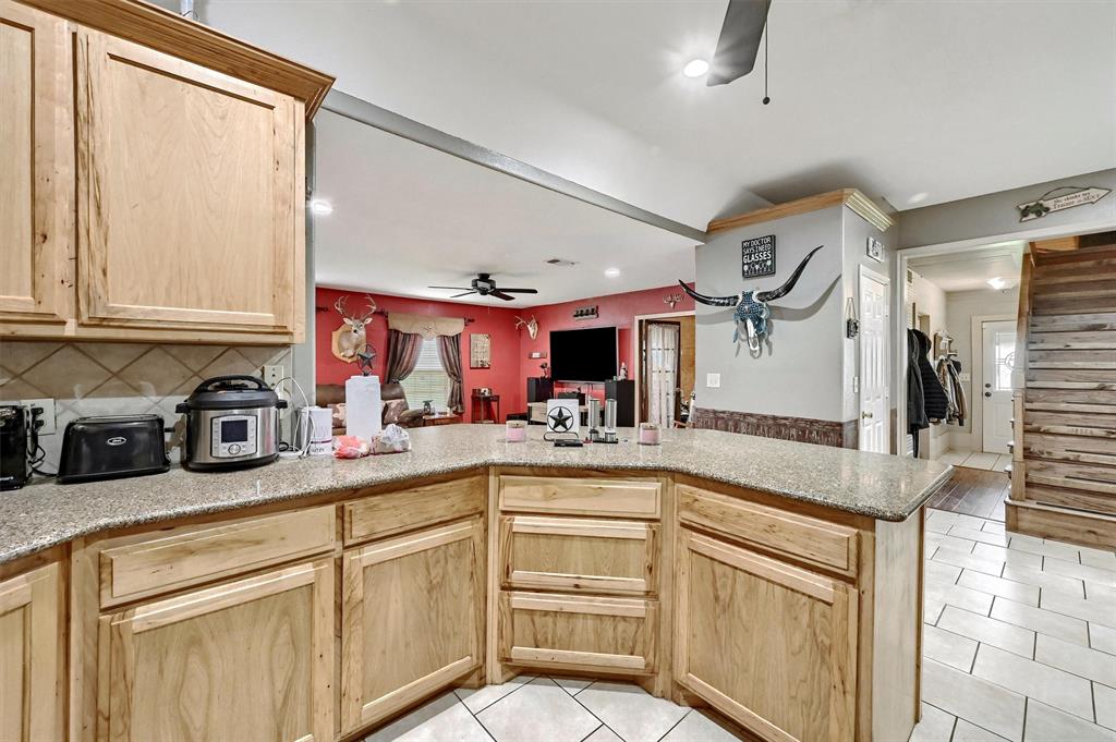 3138 Scarbrough Road Sadler, TX 76264 - Photo 19 of 40 a kitchen with stainless steel appliances granite countertop a sink and cabinets