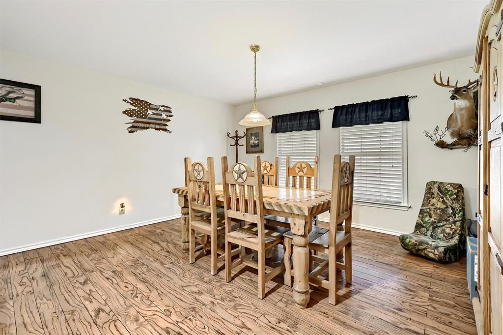 3138 Scarbrough Road Sadler, TX 76264 - Photo 21 of 40 a dining room with furniture and wooden floor