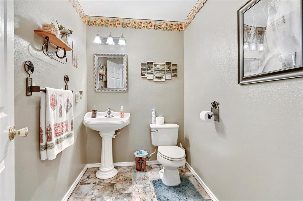 3138 Scarbrough Road Sadler, TX 76264 - Photo 22 of 40 a bathroom with a sink toilet and mirror