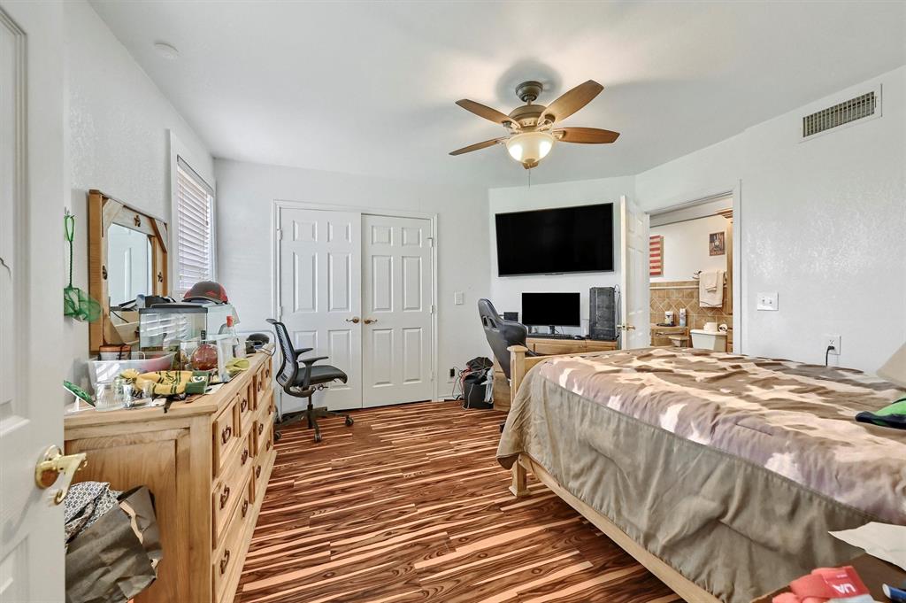 3138 Scarbrough Road Sadler, TX 76264 - Photo 23 of 40 a bedroom with a bed a flat screen tv and couches