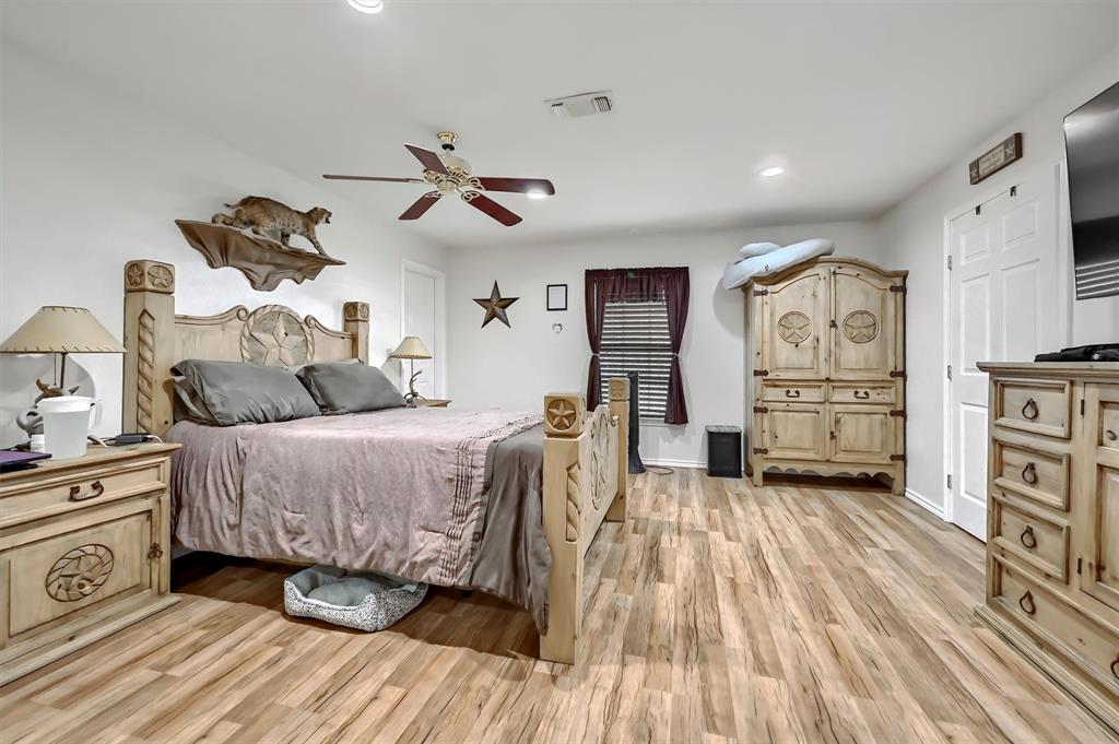 3138 Scarbrough Road Sadler, TX 76264 - Photo 26 of 40 a spacious bedroom with a bed and a cabinets