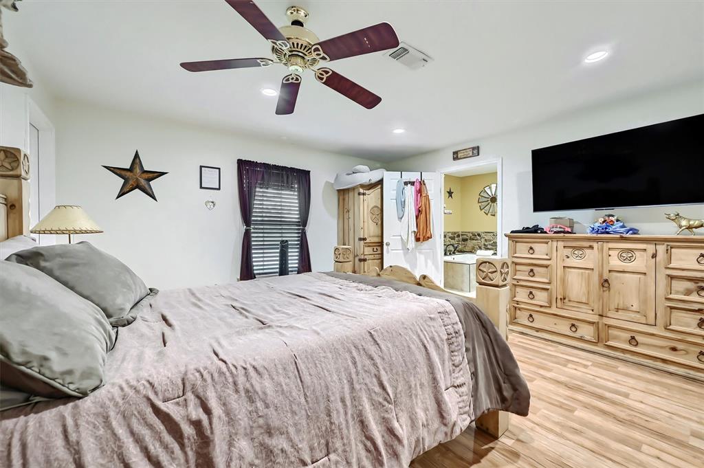 3138 Scarbrough Road Sadler, TX 76264 - Photo 27 of 40 a bedroom with a bed and a flat screen tv