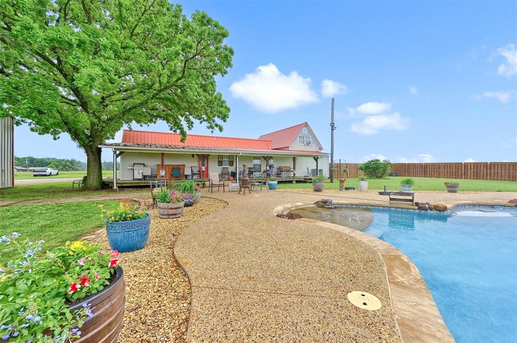 3138 Scarbrough Road Sadler, TX 76264 - Photo 8 of 40 a swimming pool with outdoor seating and garden