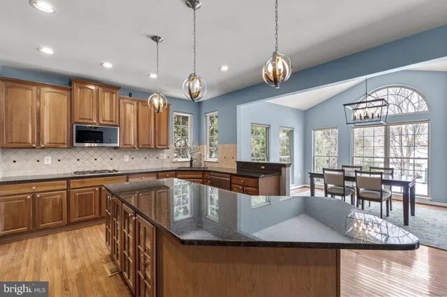 a view of a dining room with furniture a chandelier and a rug