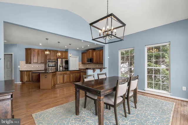 a spacious bedroom with a bed and wooden floor