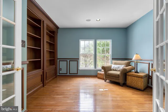 a spacious bedroom with a bed and a ceiling fan
