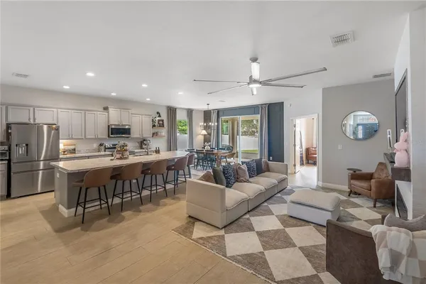 a living room with lots of furniture and kitchen view