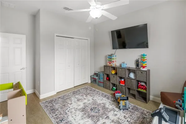 a bed room with a flat screen tv and a couch