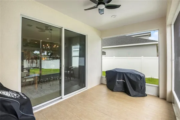 a living room with a floor to ceiling window and a table